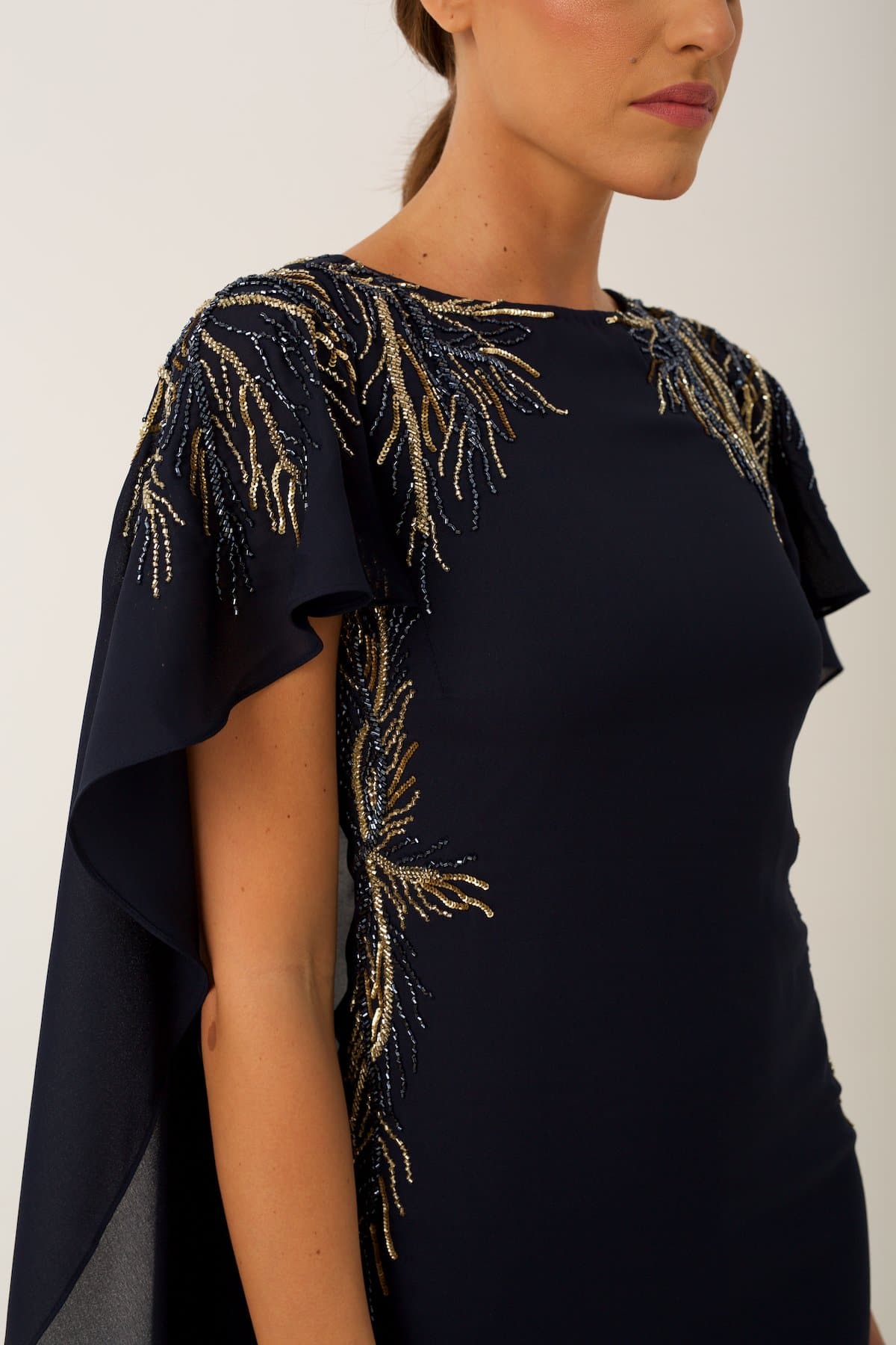  elegant cocktail dress features sublet embroidery on the shoulders and on the sides of the waist 