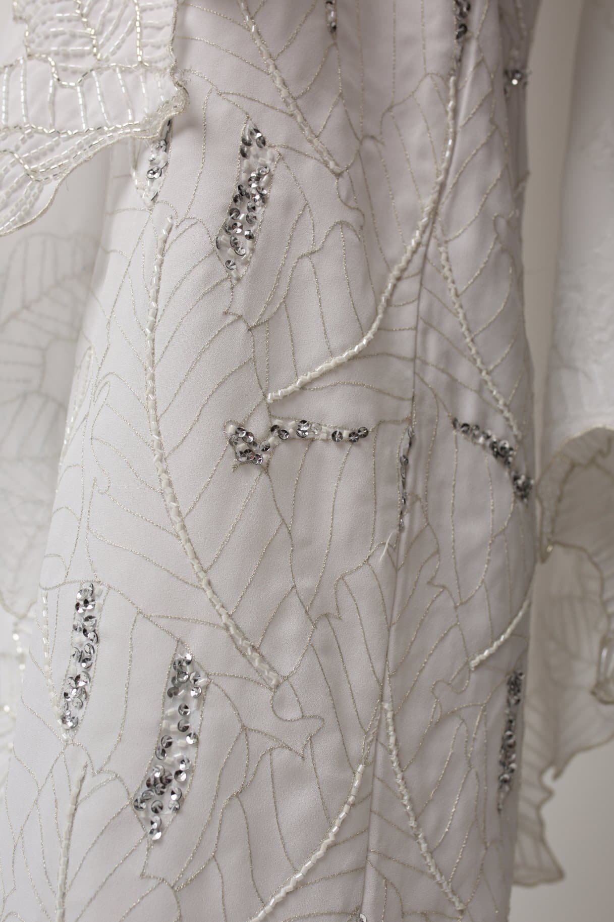 bridal dress with a waterfall-like drape sleeve 